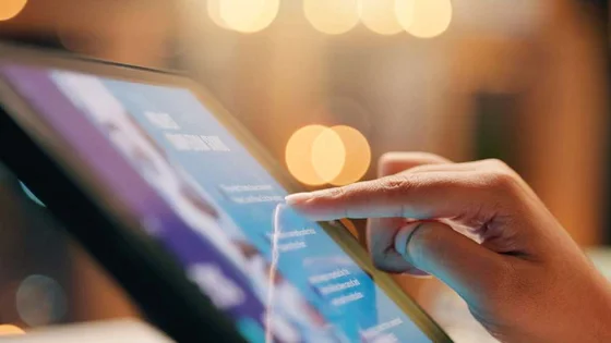 Close-up of a hand interacting with a digital tablet