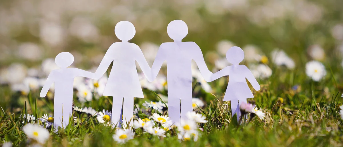 image of paper family on grass