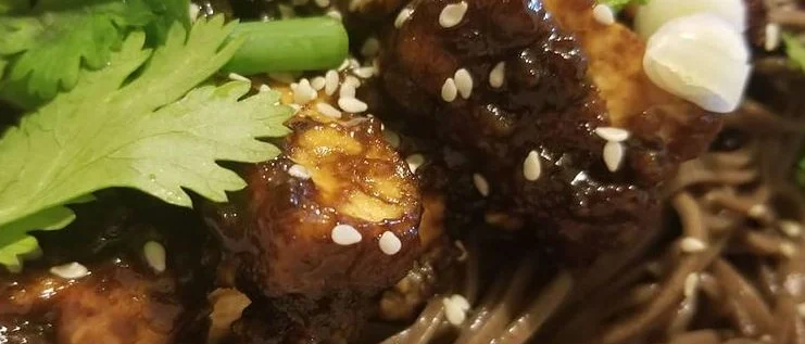 Szechuan Tofu in a black bean sauce over soba noodes