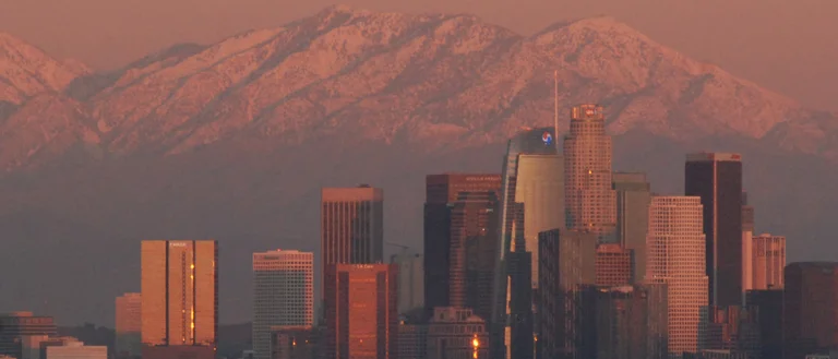 LA at sunset with snowy mountains