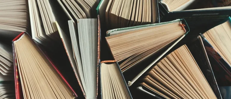 Books half-opened in a pile. 