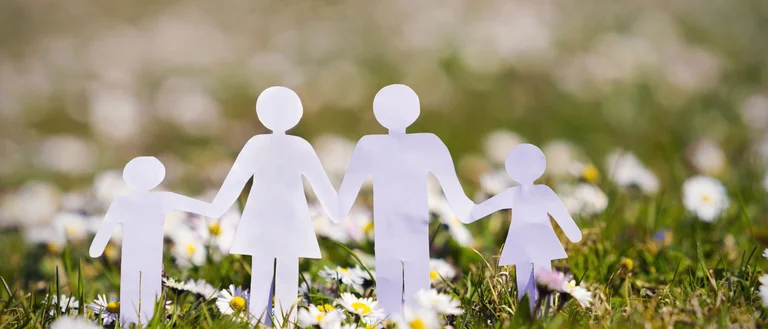 image of paper family on grass