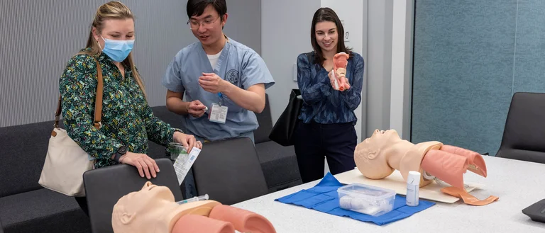 Three UCLA members viewing simulation models