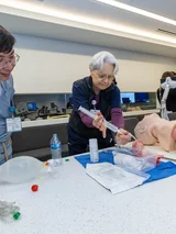 Instructor and student practicing operation on model