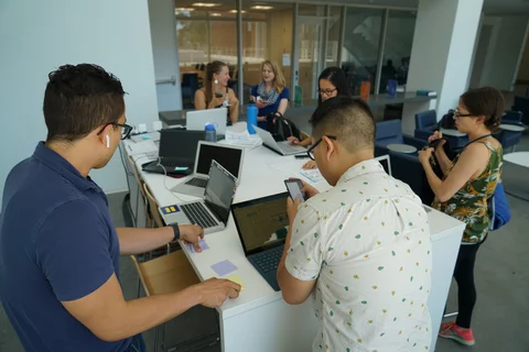group of people working together at one table