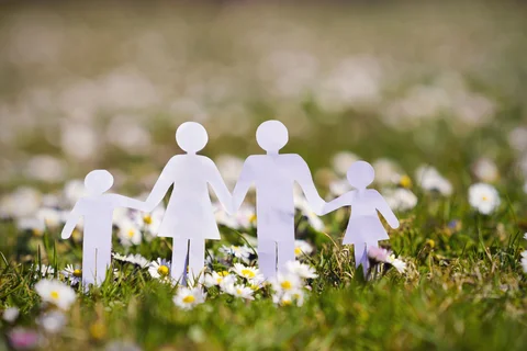 image of paper family on grass