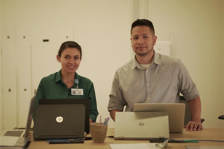 Two people working on their computers