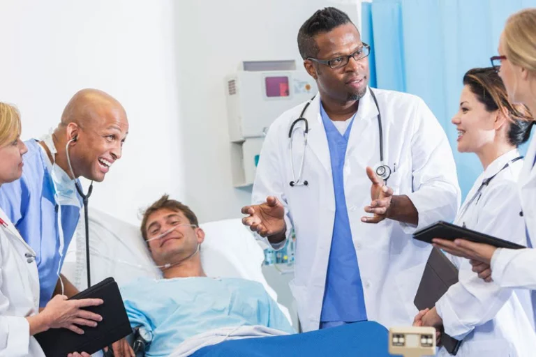 A team of doctors discussing something with a patient on the hospital bed