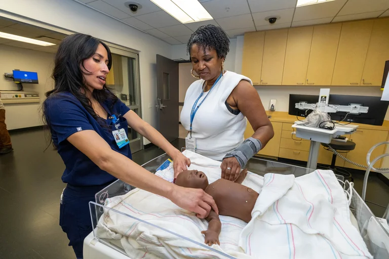 Two professionals at the simulation center opening event