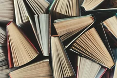 Books half-opened in a pile.