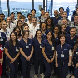 A group photo of physicians, doctors, trainees, and staff associated with the simulation center 