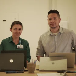 Two people working on their computers