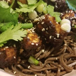 Szechuan Tofu in a black bean sauce over soba noodes