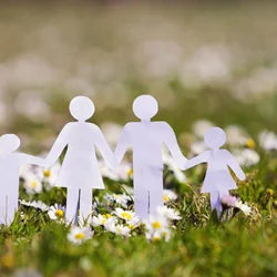 image of paper family on grass