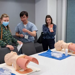 Three UCLA members viewing simulation models
