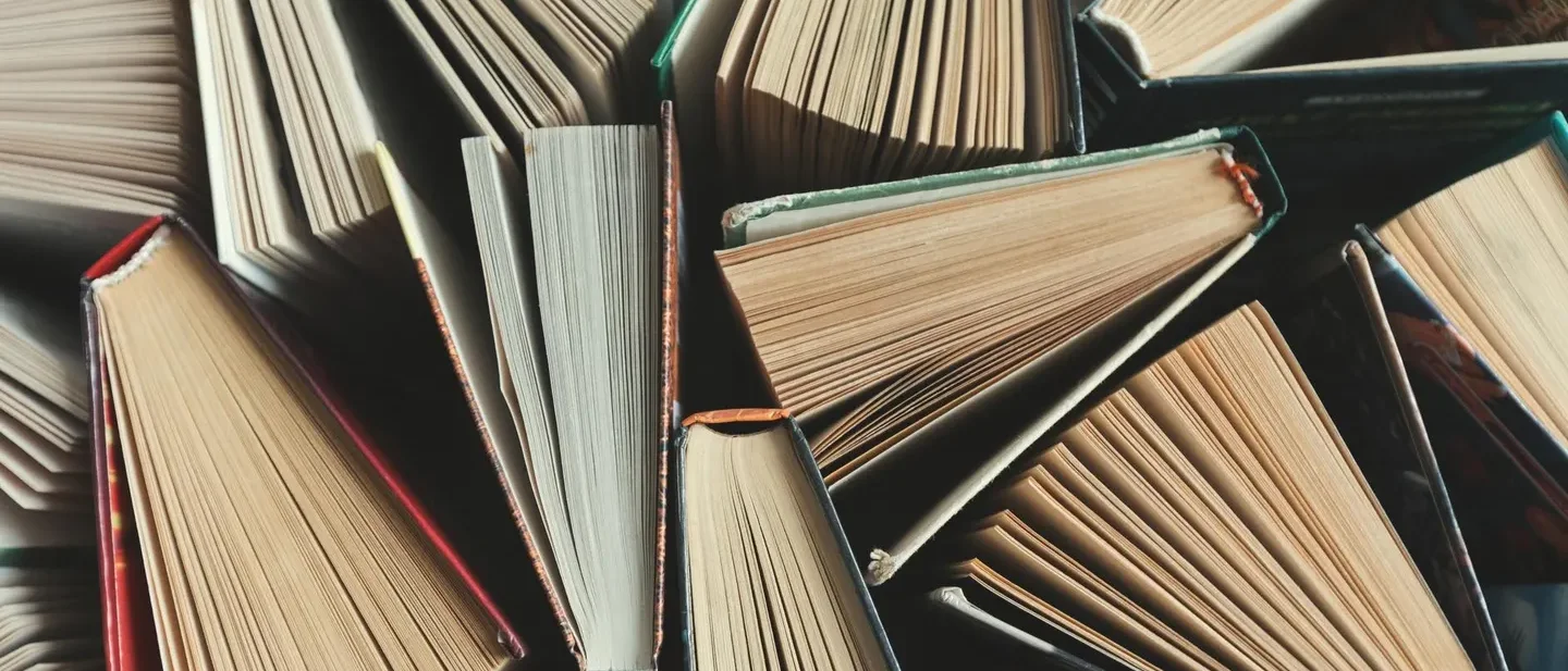 Books half-opened in a pile.