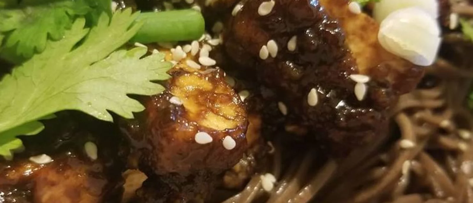 Szechuan Tofu in a black bean sauce over soba noodes