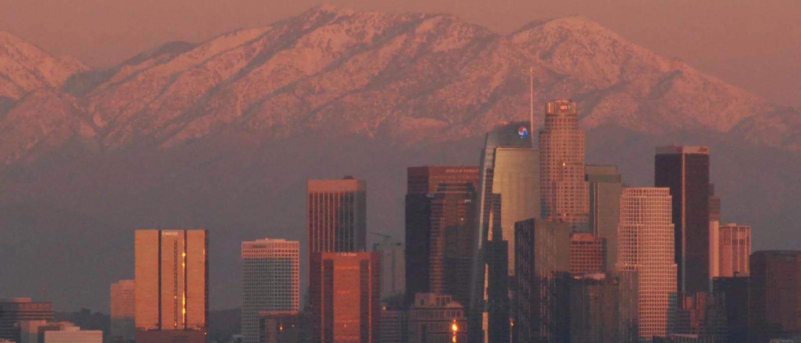 LA at sunset with snowy mountains