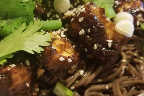 Szechuan Tofu in a black bean sauce over soba noodes