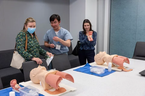 Three UCLA members viewing simulation models