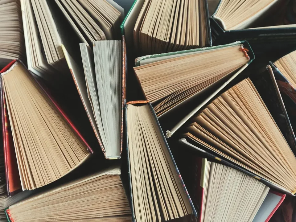 Books half-opened in a pile. 