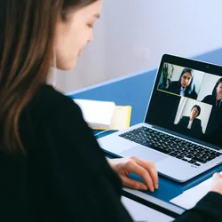Woman on Zoom with other women