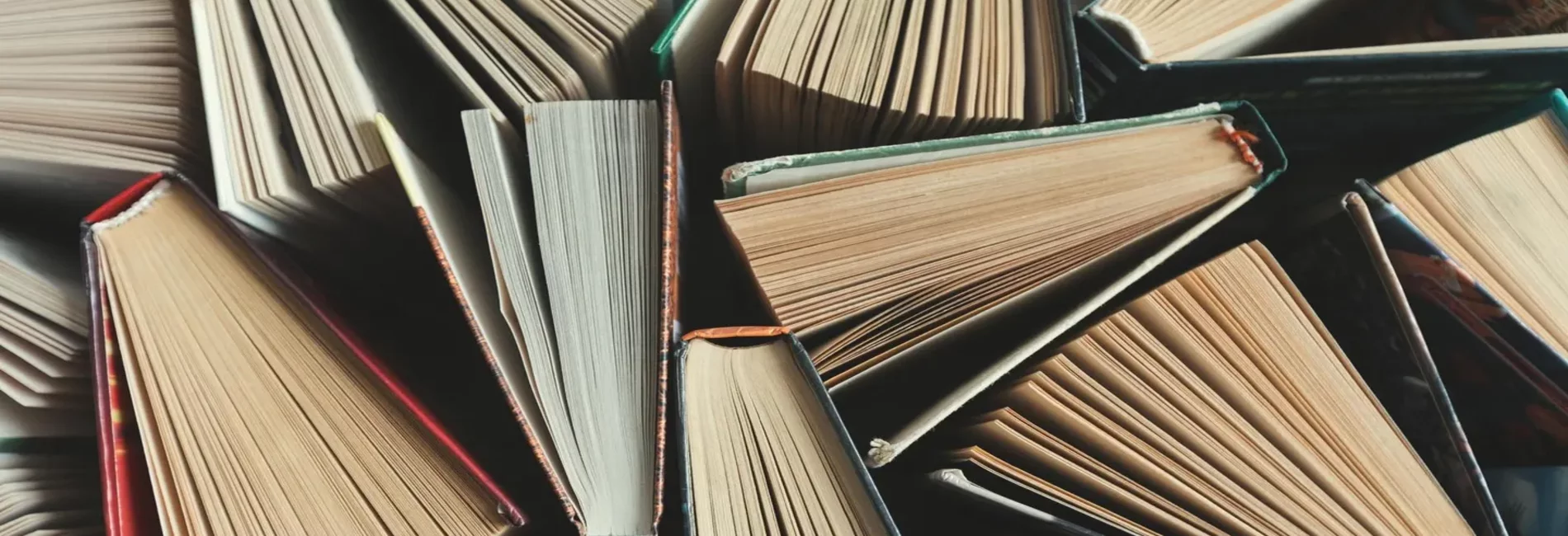 Books half-opened in a pile.